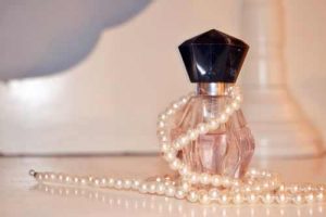 pearls and a bottle of perfume
